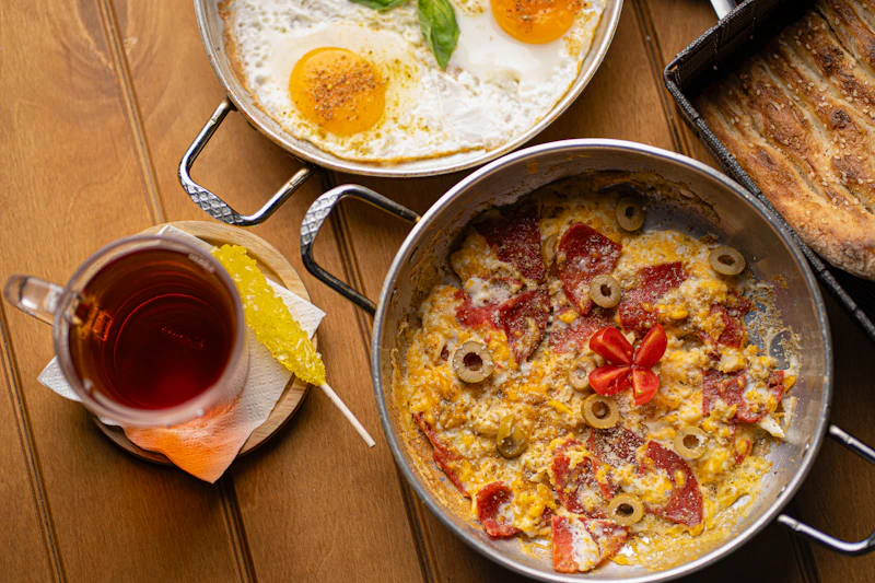 Breakfast with eggs, bread, vegetables and tea