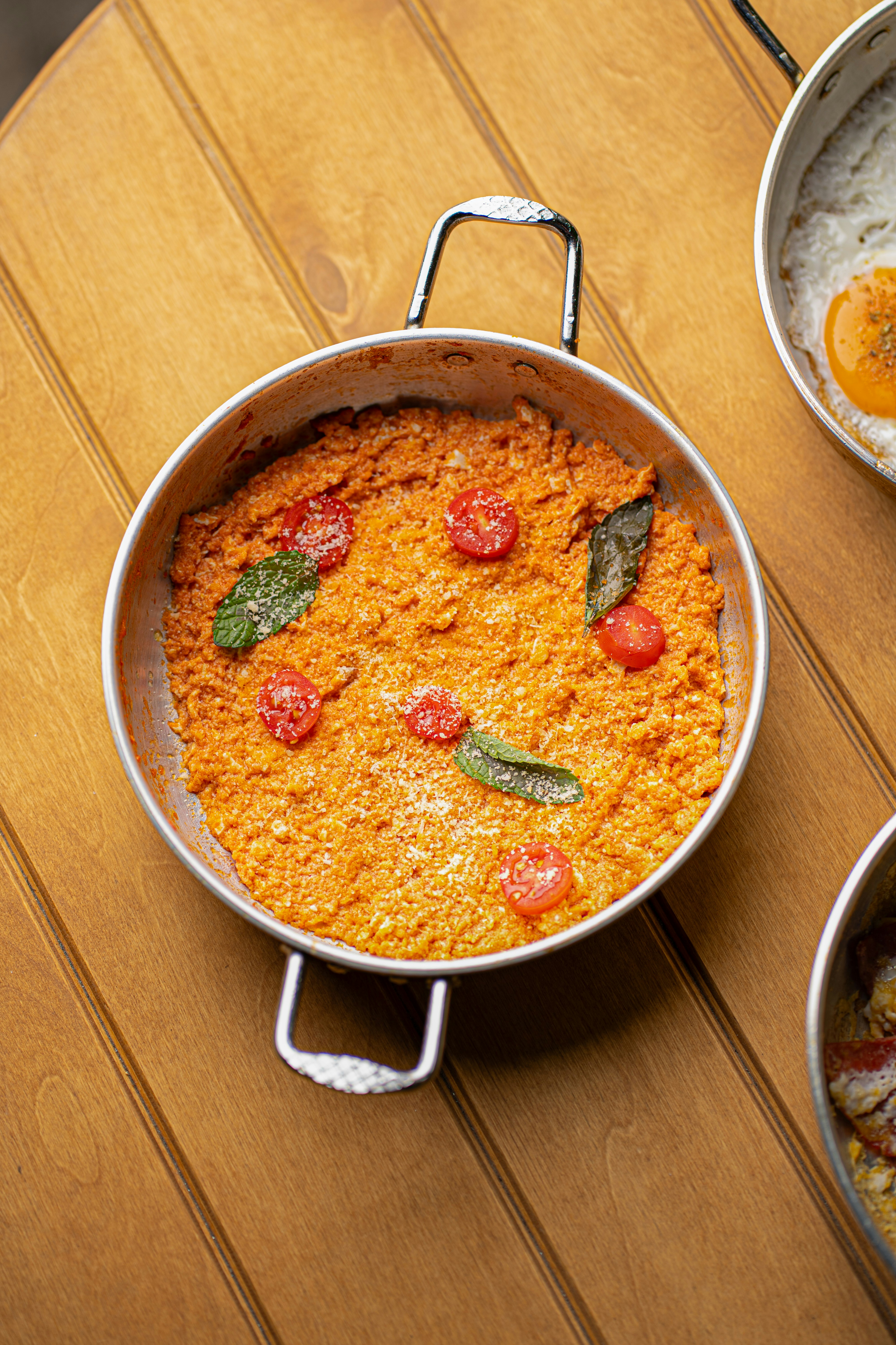 Prato cozido salgado com tomates e ervas na panela