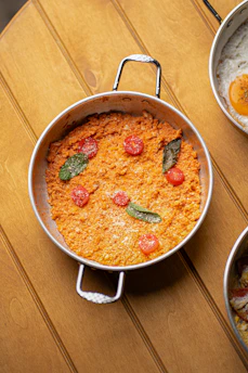 Savory baked dish with tomatoes and herbs in pan