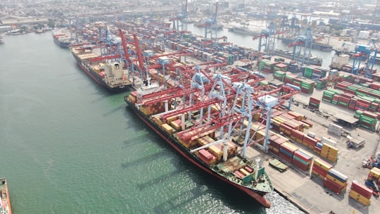 Cargo ships being loaded at a busy port.