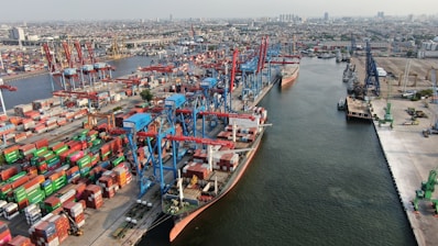 Busy shipping port with cranes and cargo containers