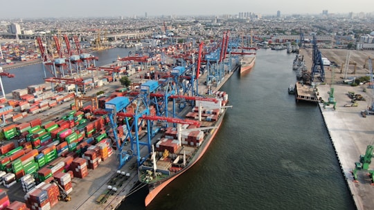Busy shipping port with cranes and cargo containers