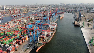 Busy shipping port with cranes and cargo containers