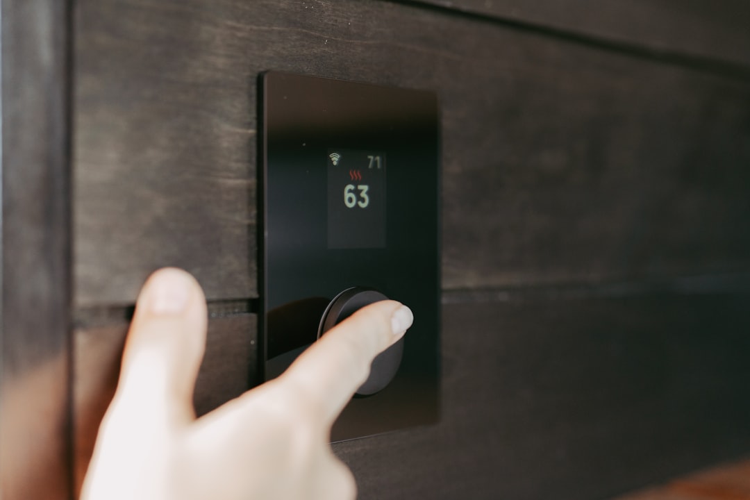 homeowner checking a digital thermostat for power and settings - what to do when your hvac breaks down unexpectedly homeowner checking a digital thermostat for power and settings - what to do when your hvac breaks down unexpectedly