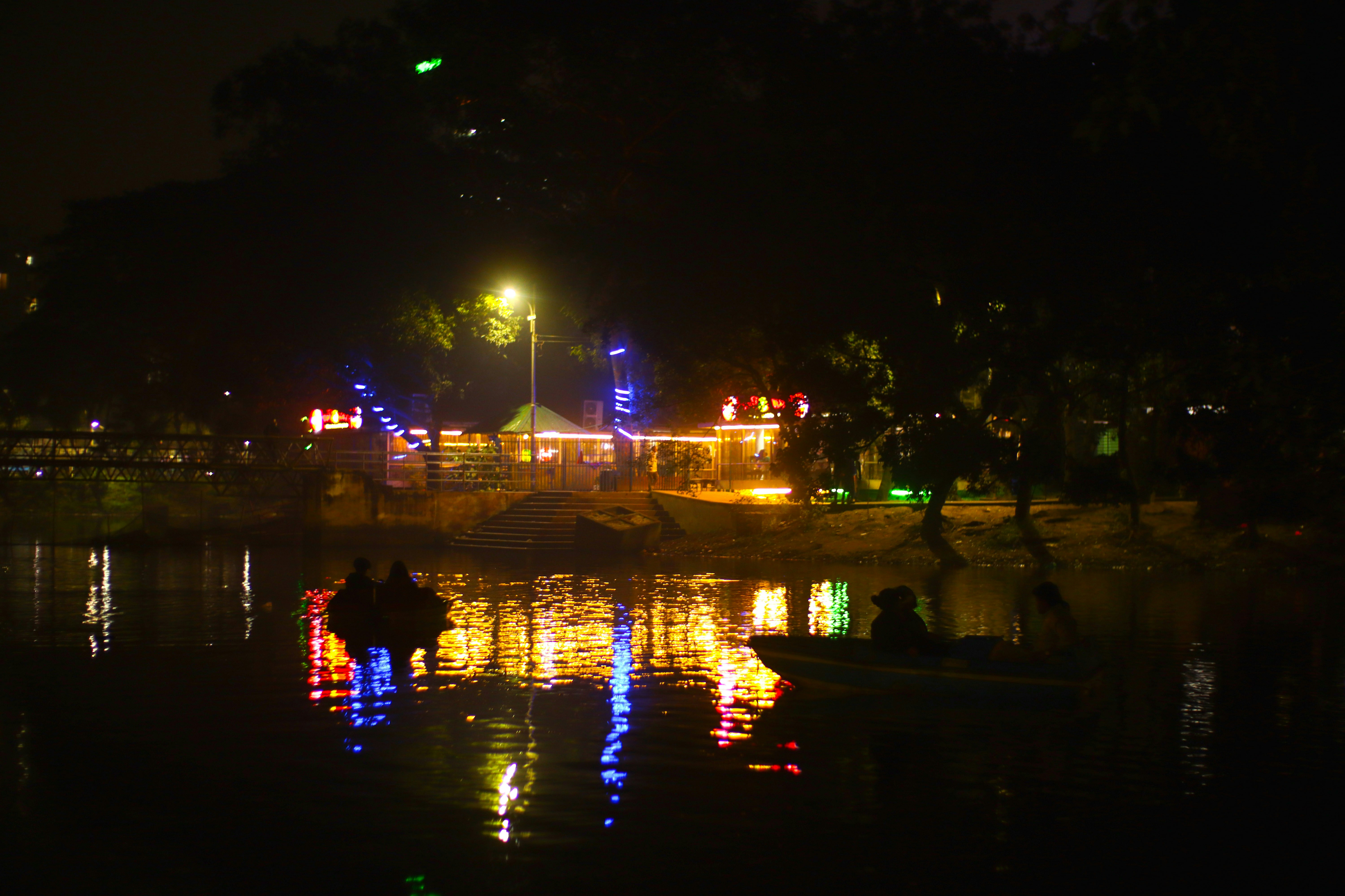 Boats on lake with colorful lights