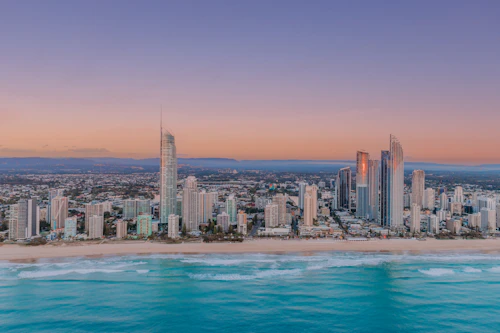 Gold Coast high-rise skyline in soft morning light beside the ocean