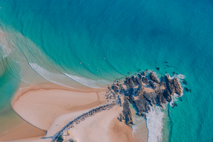 Aerial view of a rocky turquoise coastline in Australia