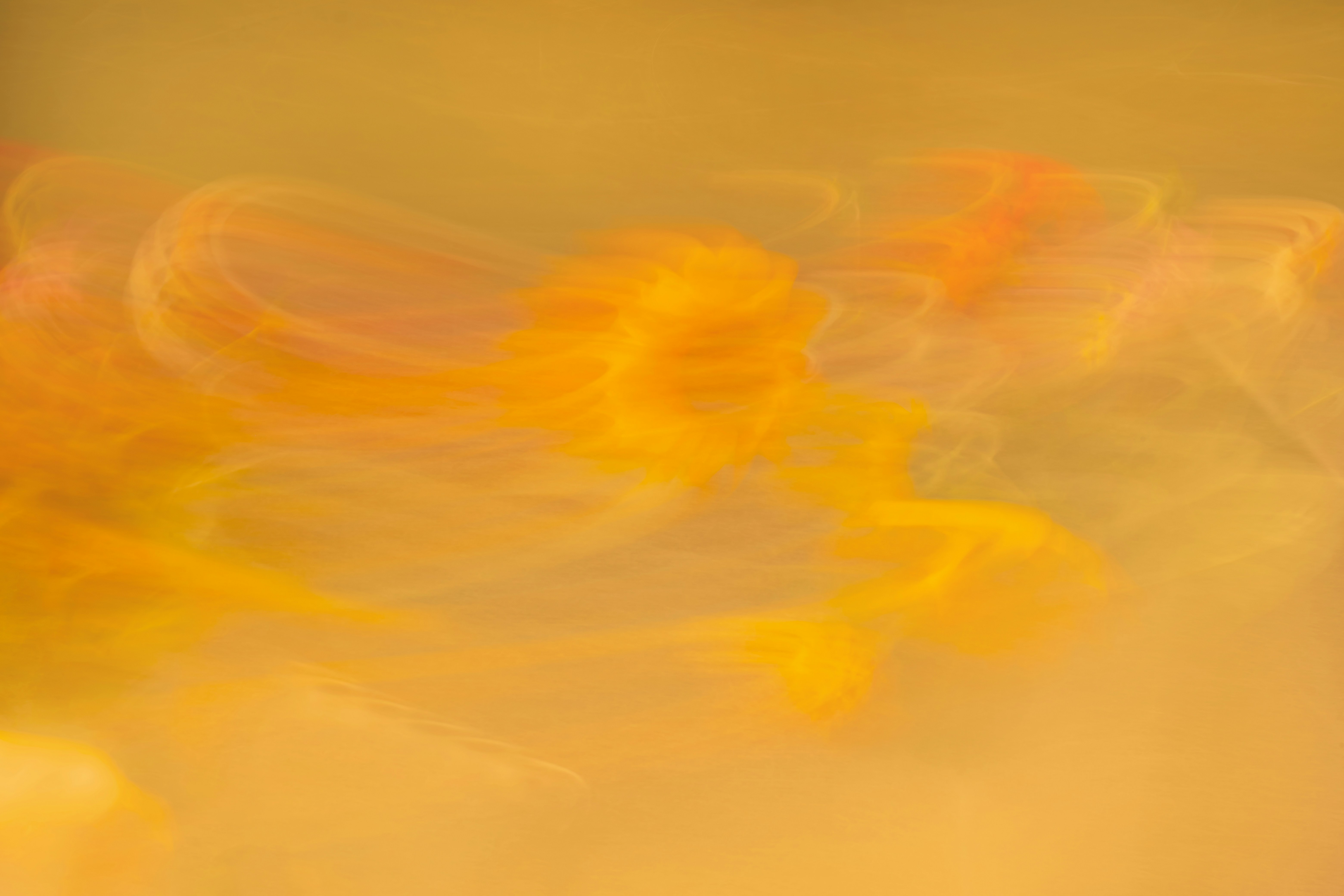 Abstract swirls of orange and yellow light