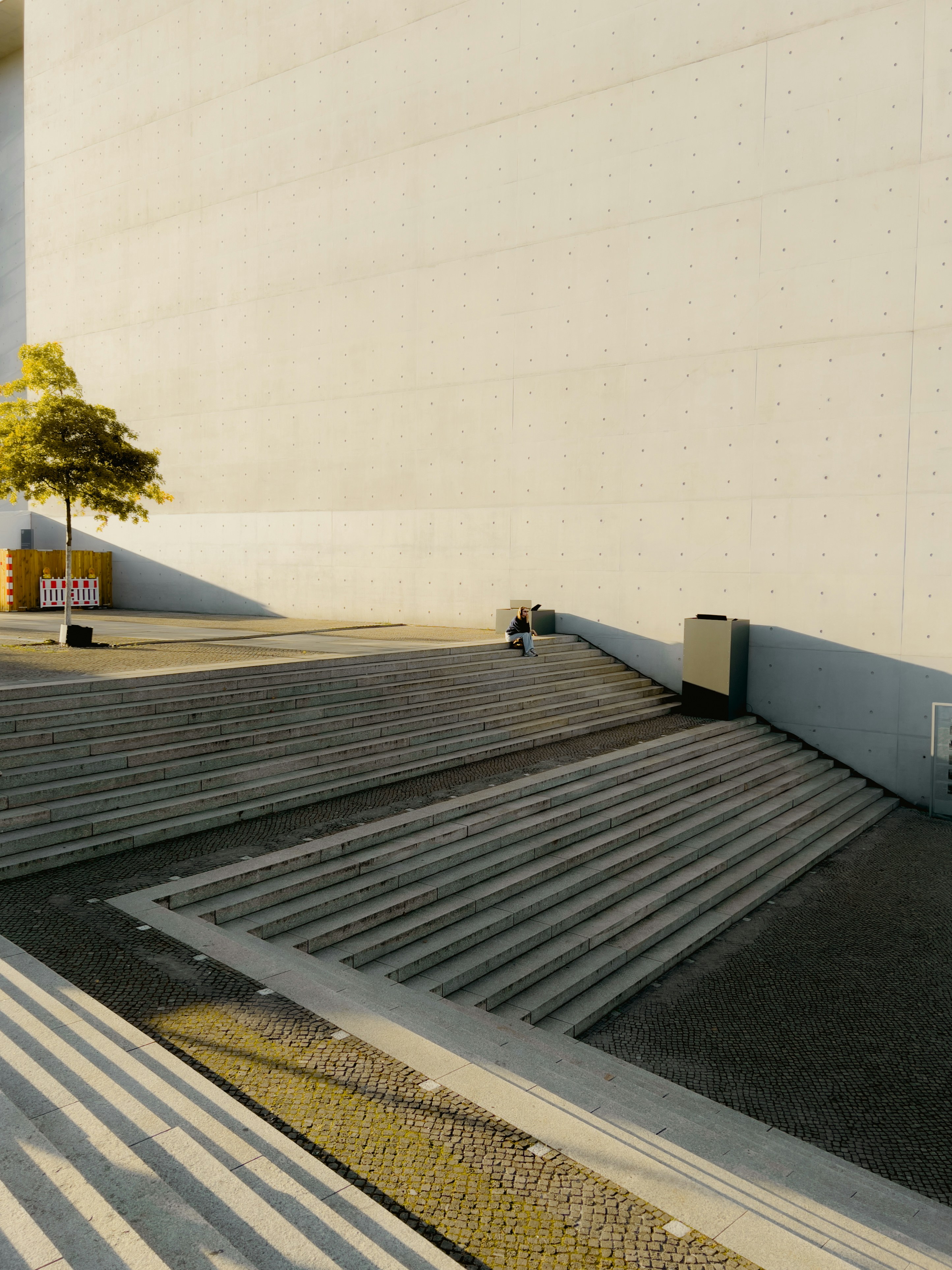 Modern concrete stairs leading to a building entrance.