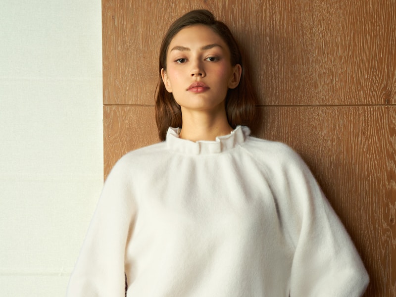 Elegant woman in refined white sweater