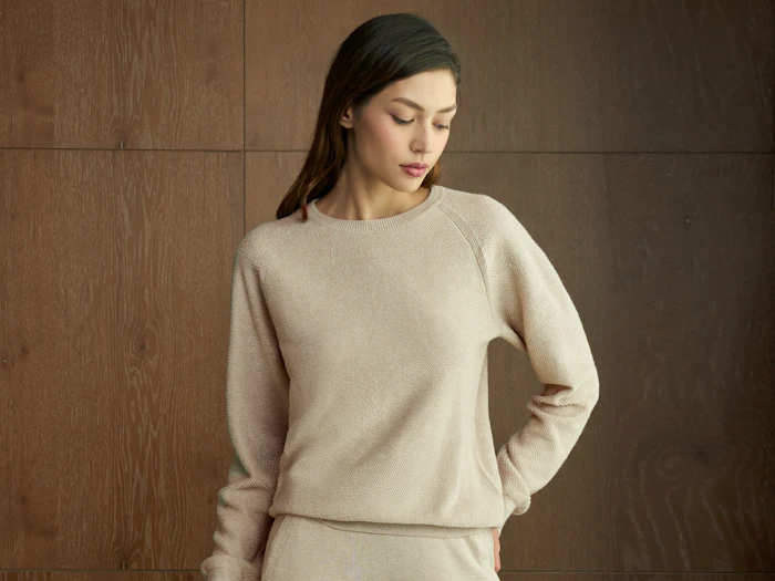 Model in a soft beige knit loungewear set