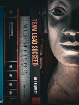 Books and a bust on a shelf