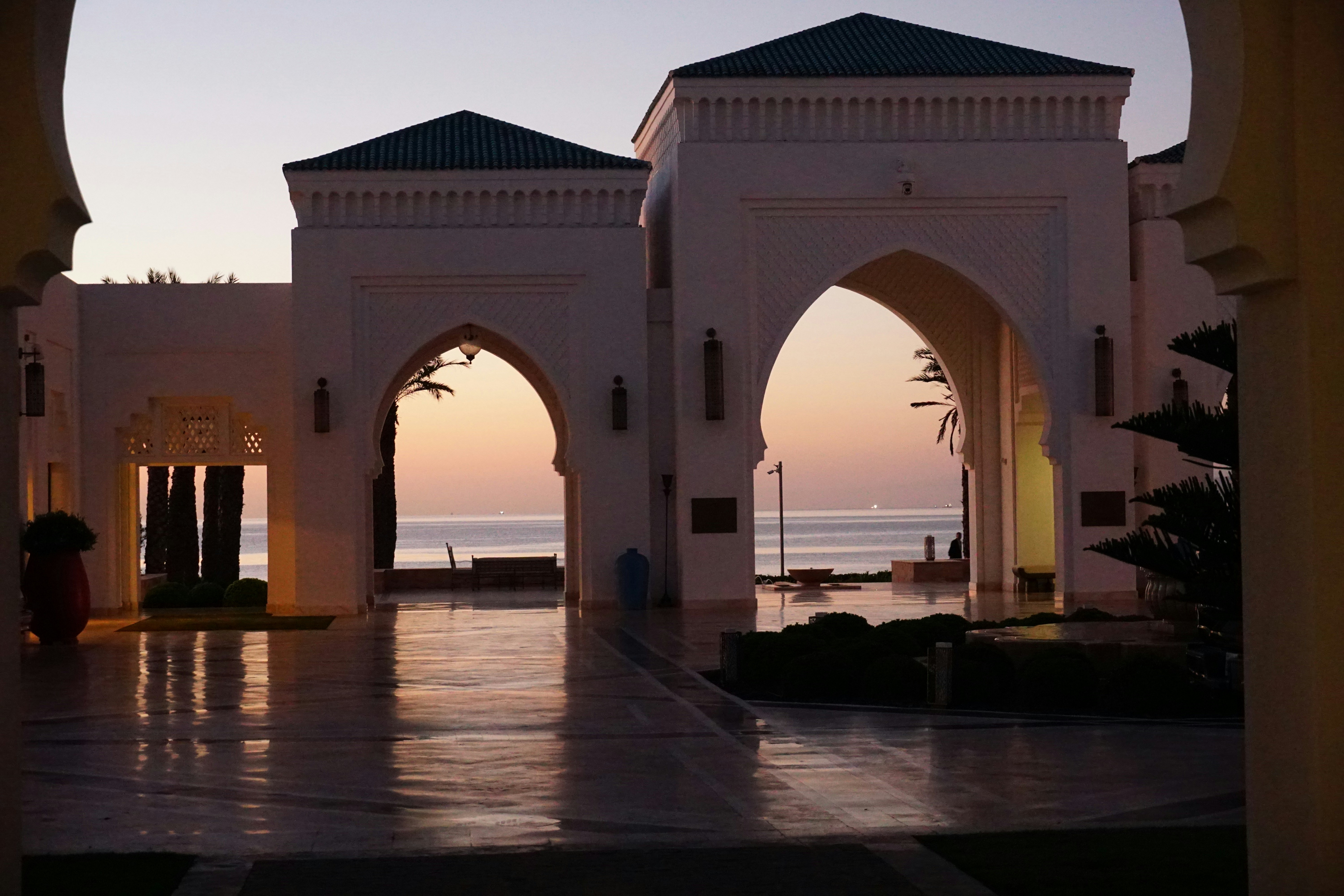 Arches leading to ocean at sunset