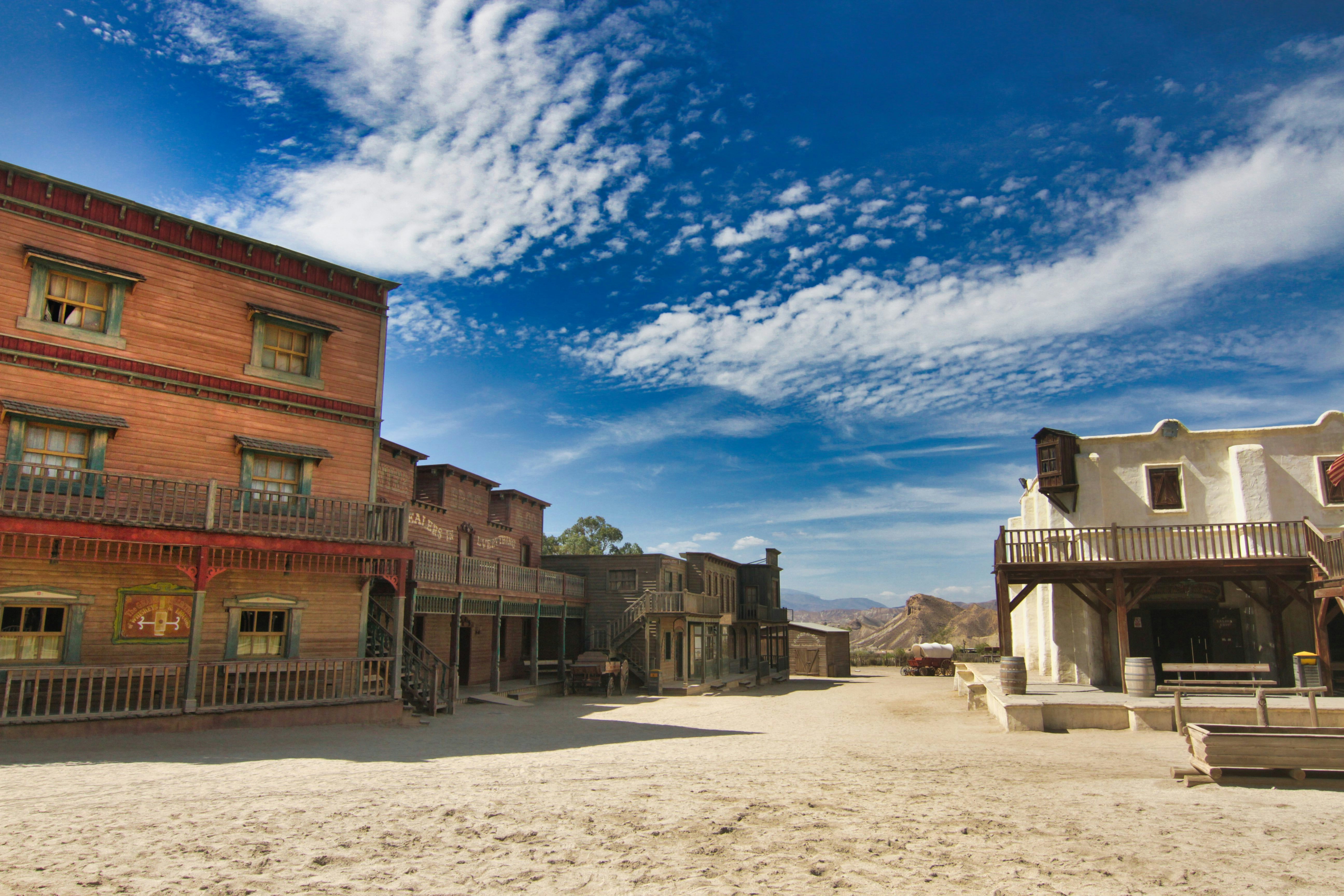 Old western town street with buildings under blue sky photo – Free Desert  Image on Unsplash, image size:3000x2000