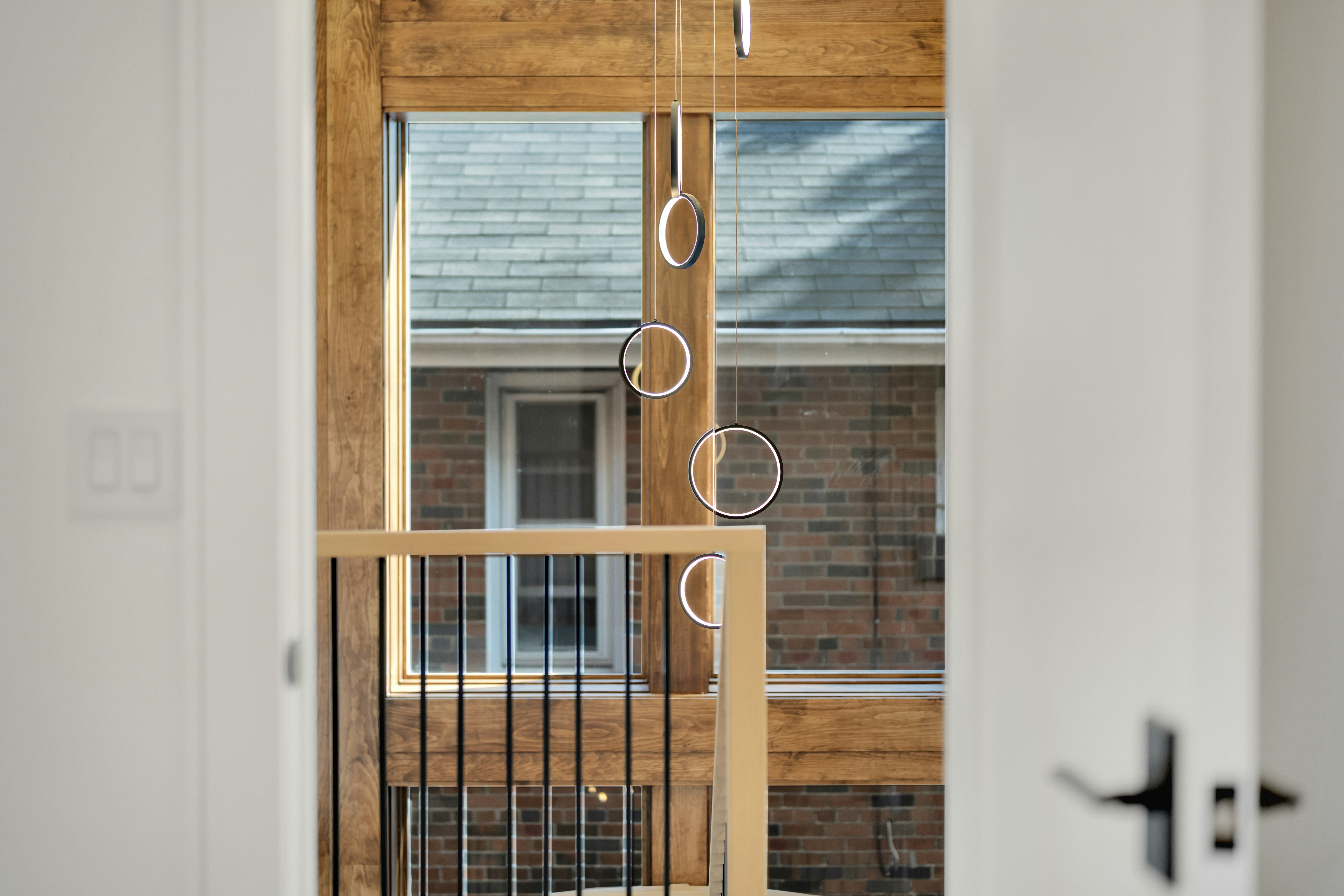 Gymnastic rings hanging from wooden beams indoors