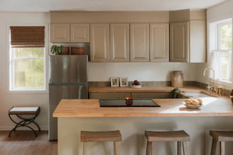 A modern kitchen with light wood countertops and island