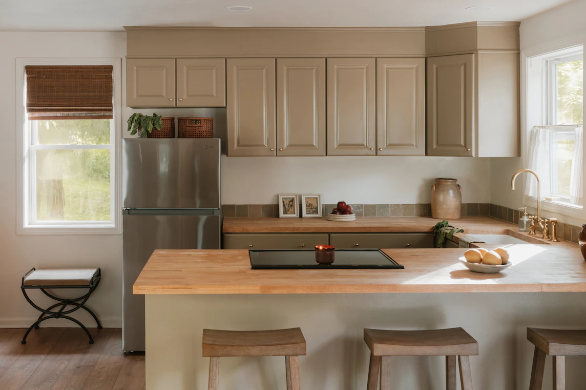 Modern kitchen with light wood countertops and island