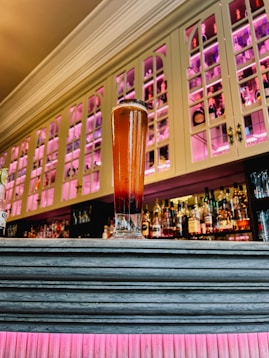 Tall glass of dark beer on a bar counter
