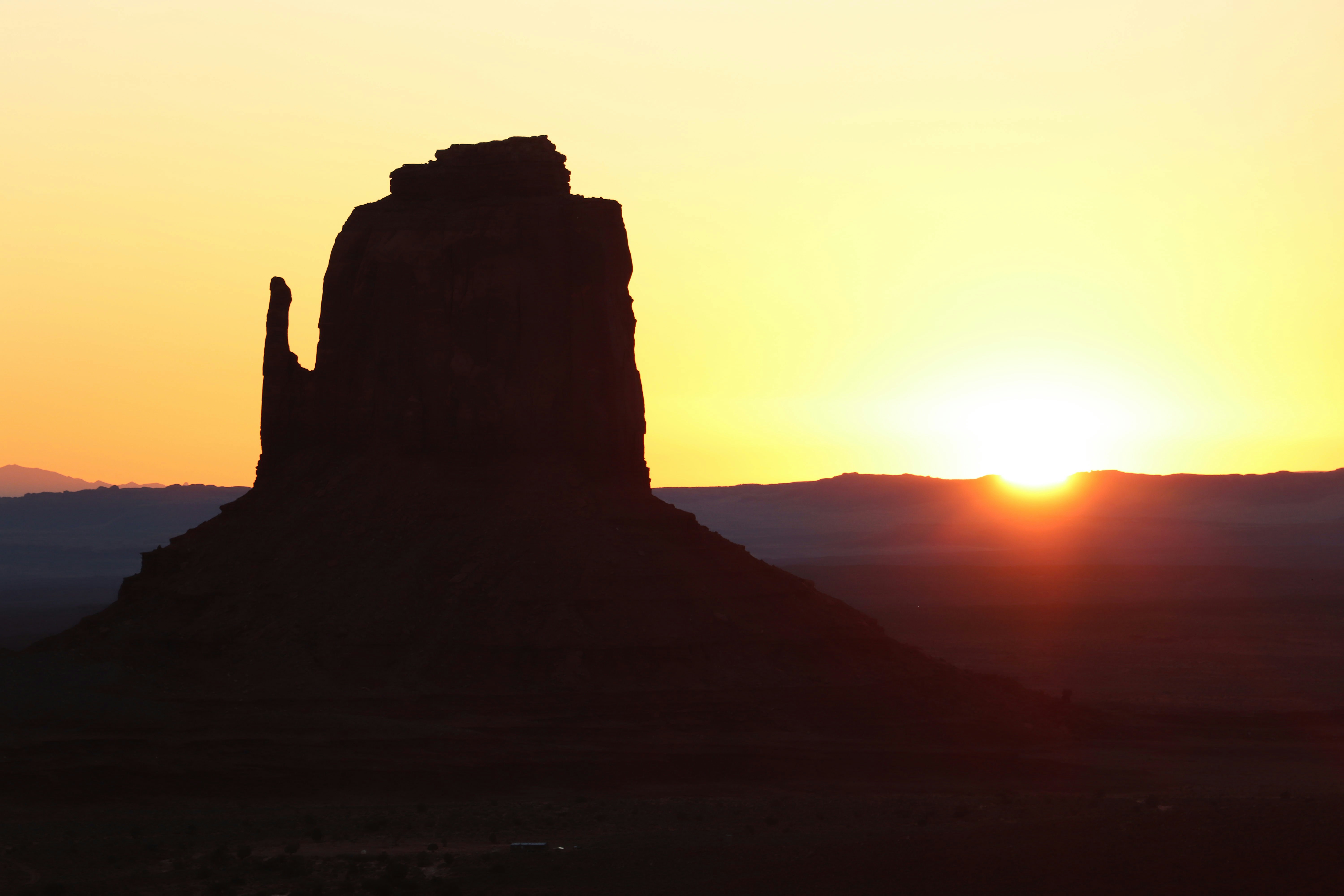 Valle de los monumentos al atardecer con una gran formación rocosa.