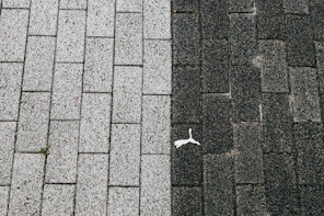 Two contrasting textures of brick paving stones.