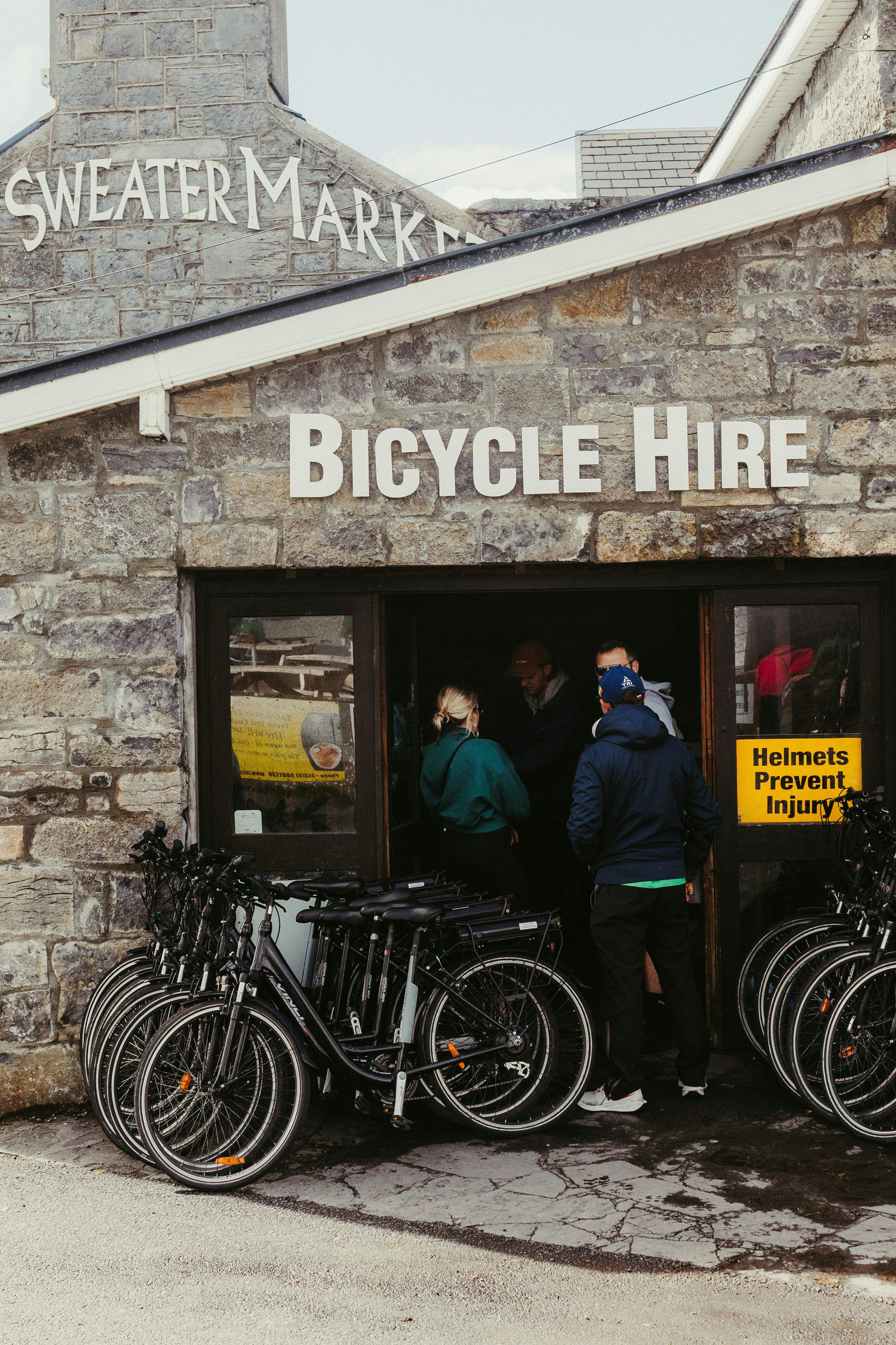 Bicycles lined up outside a bicycle hire shop.