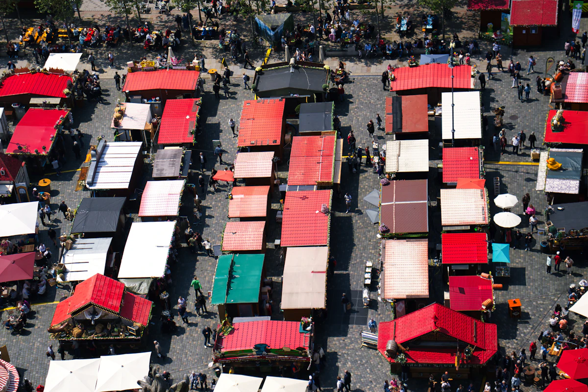 A busy outdoor market with many stalls from above