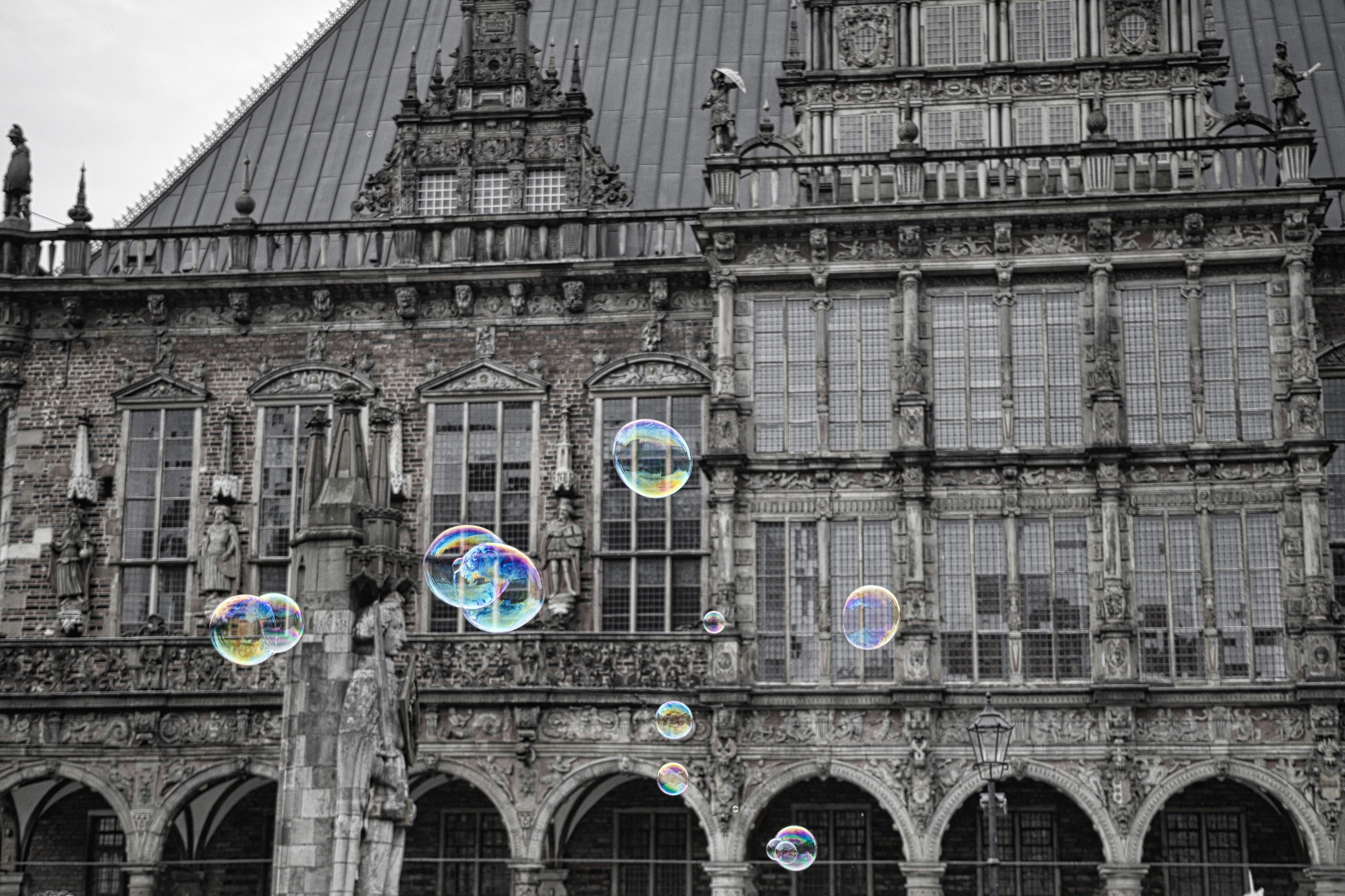 Bubbles float in front of historic building facade