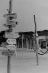 Directional signs point to various countries and distances.