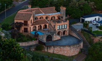 Castle-like mansion with a pool and courtyard.