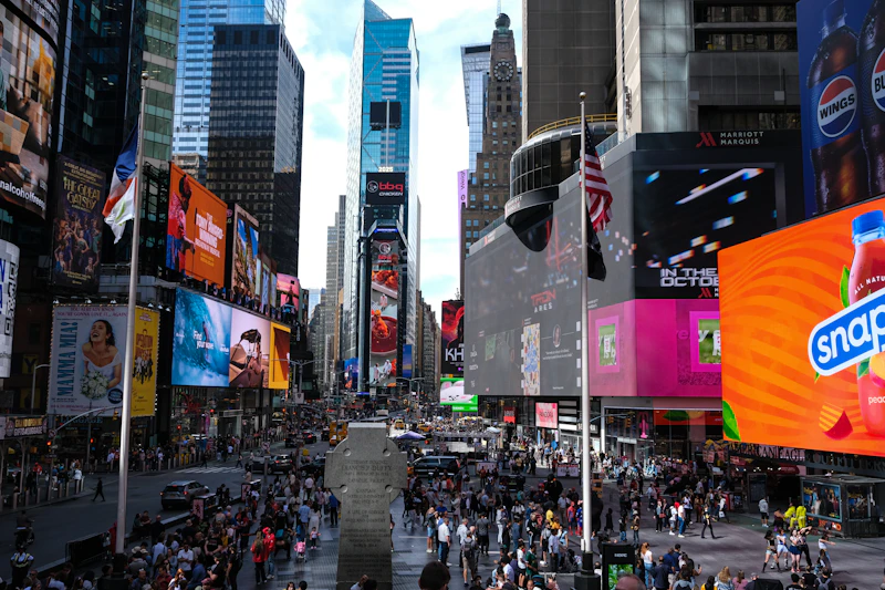 Bright neon billboards and crowded pedestrians at Times Square in Manhattan