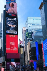 Brightly lit billboards in a bustling city square.