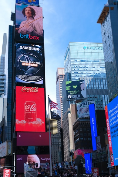 Brightly lit billboards in a bustling city square.