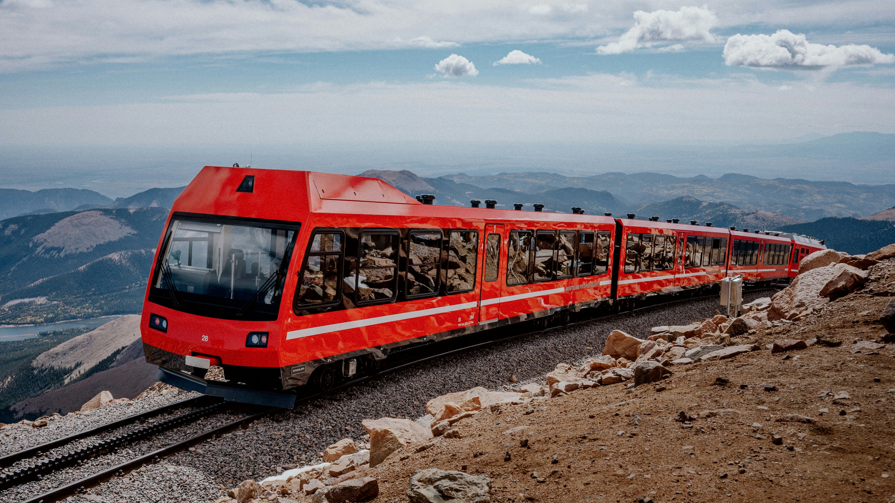 Red cog railway train on mountain tracks