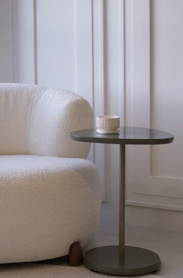 A cozy armchair next to a small side table.