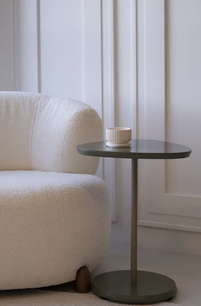 A cozy armchair next to a small side table.