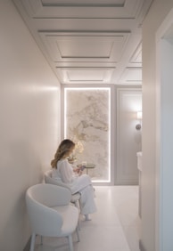 Woman sitting in a modern waiting room reading
