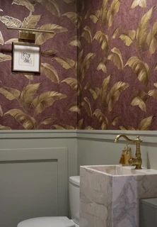 Powder room with floral wallpaper and marble sink
