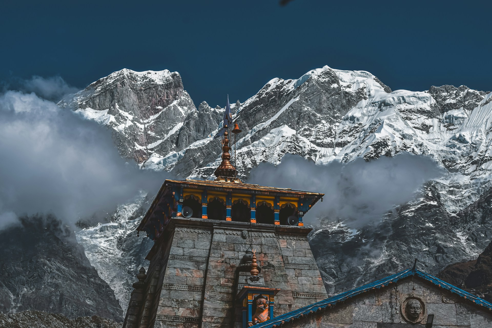 Stone temple in front of snow-capped mountains