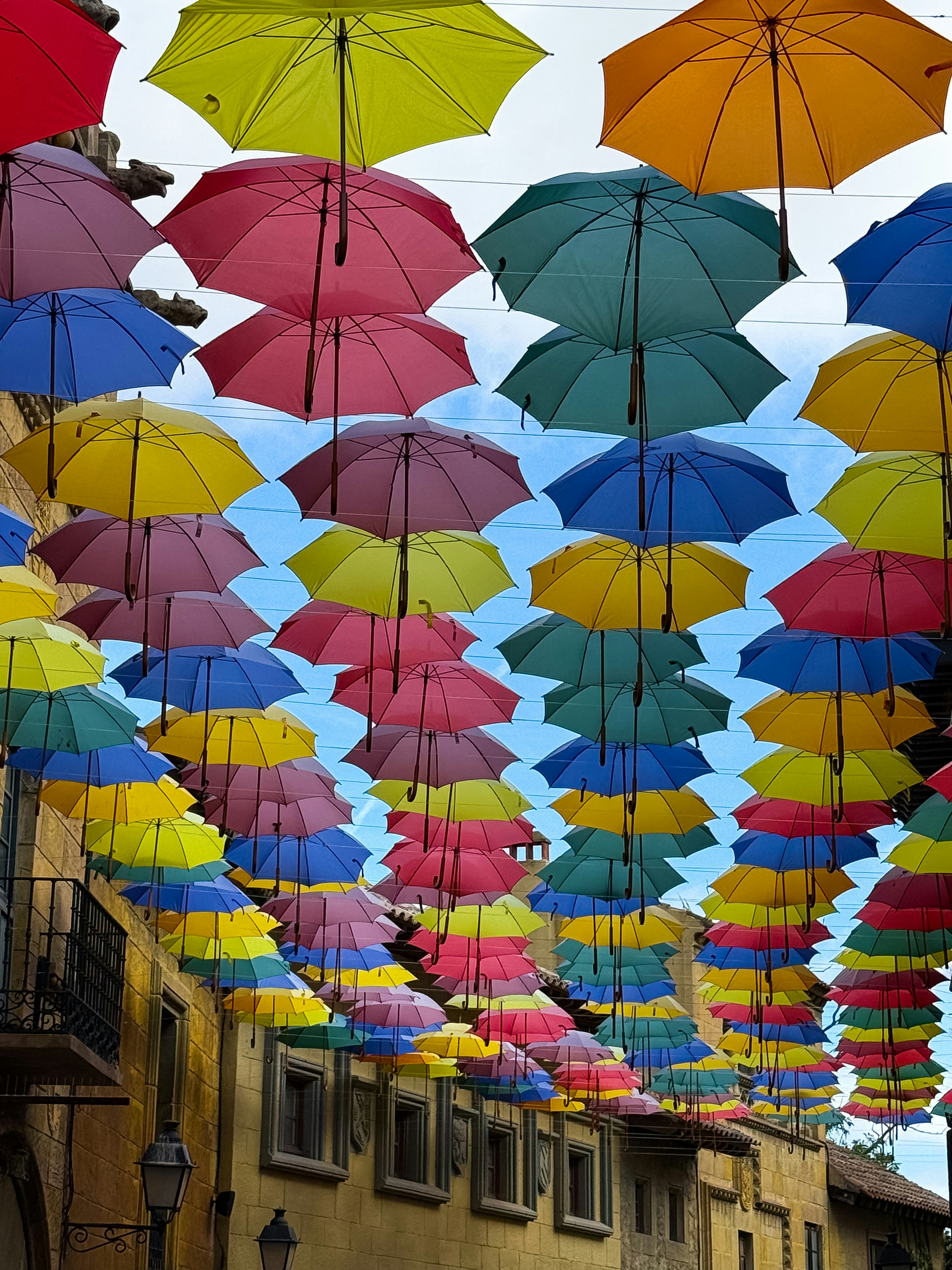 Colorful umbrellas suspended over a street