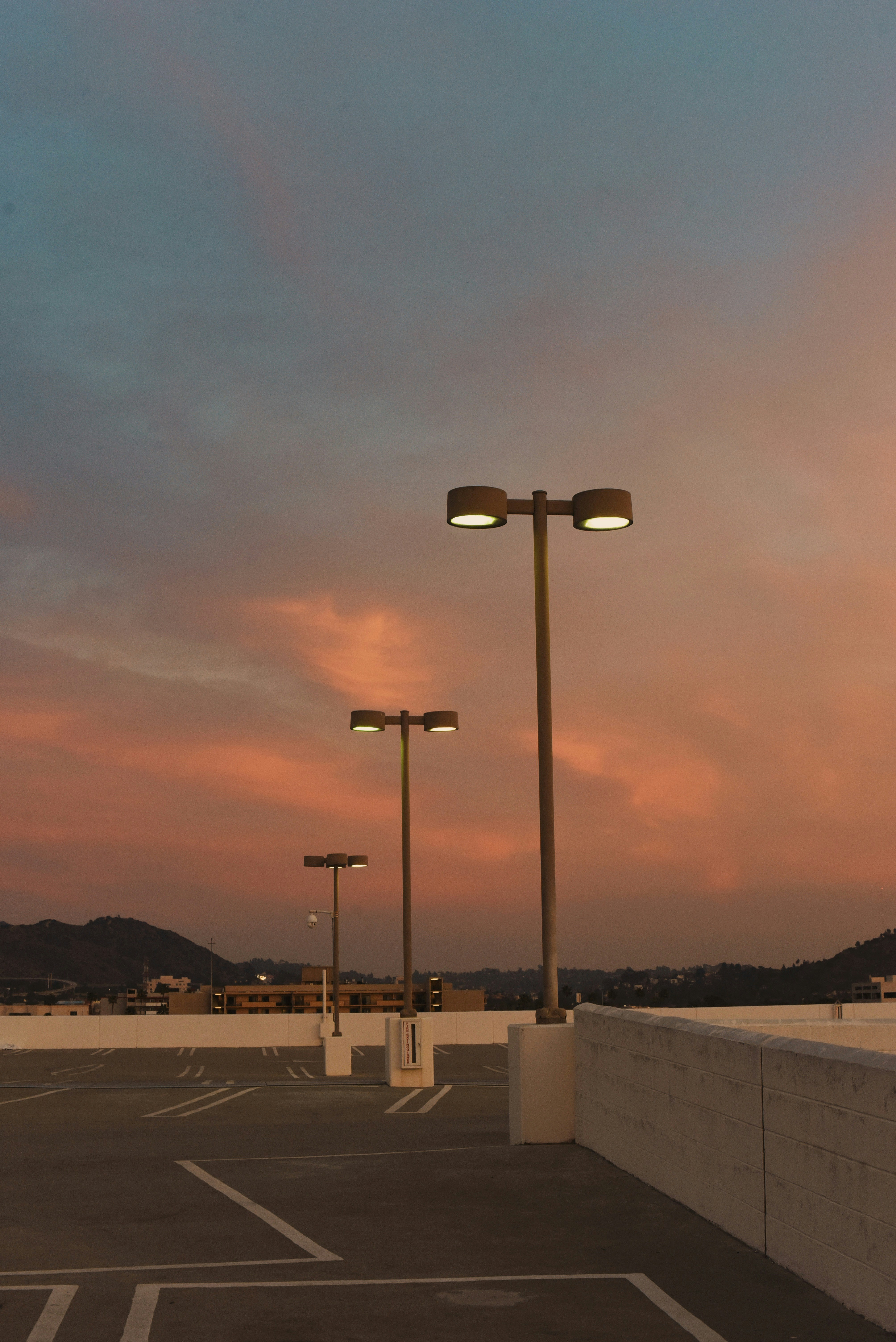 Streetlights on a parking lot at sunset