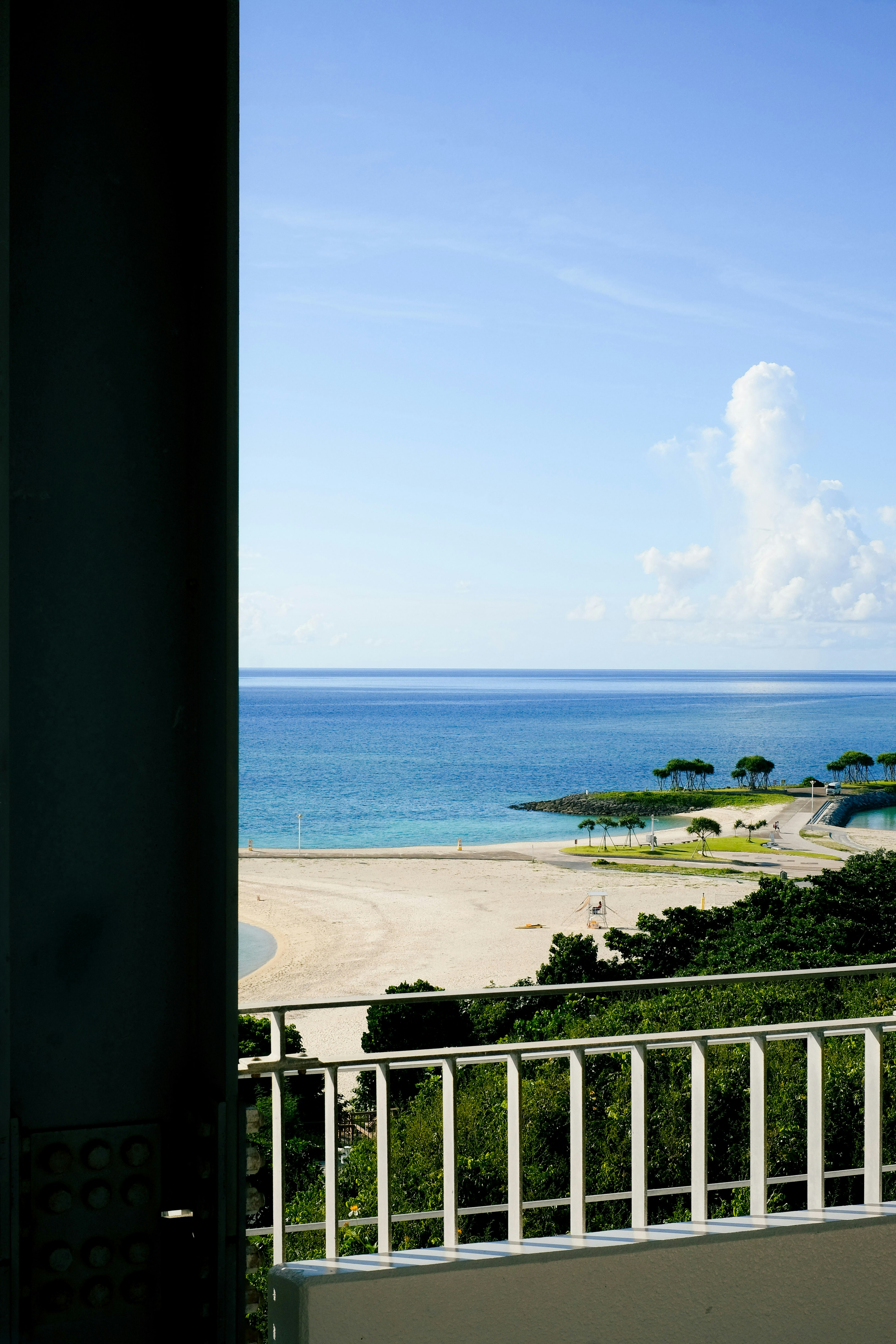 Shaded beach house veranda with ocean breeze and rattan seating