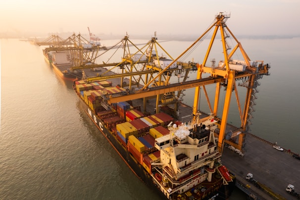 Cargo ship being loaded at a port with cranes