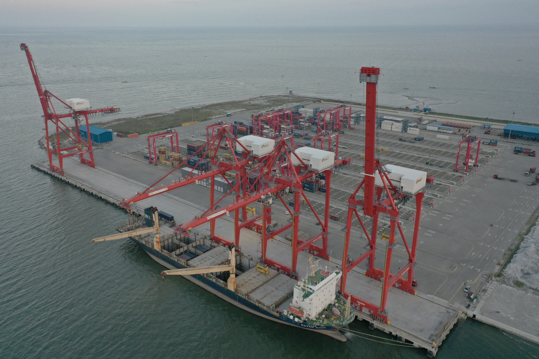 Cargo vessel and port cranes representing trade finance due diligence and international commerce