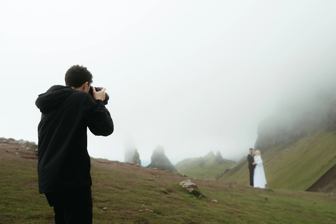Couple during their elopement in Argentine Patagonia with the single vertical granite needle of Cerro Torre rising from the glacial lake behind them
