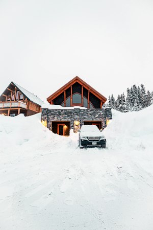 An SUV waiting in the plowed driveway of a snowy house &mdash; a holiday car rental in New Hampshire delivered for visiting family