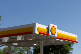 Shell gas station canopy with logo under blue sky