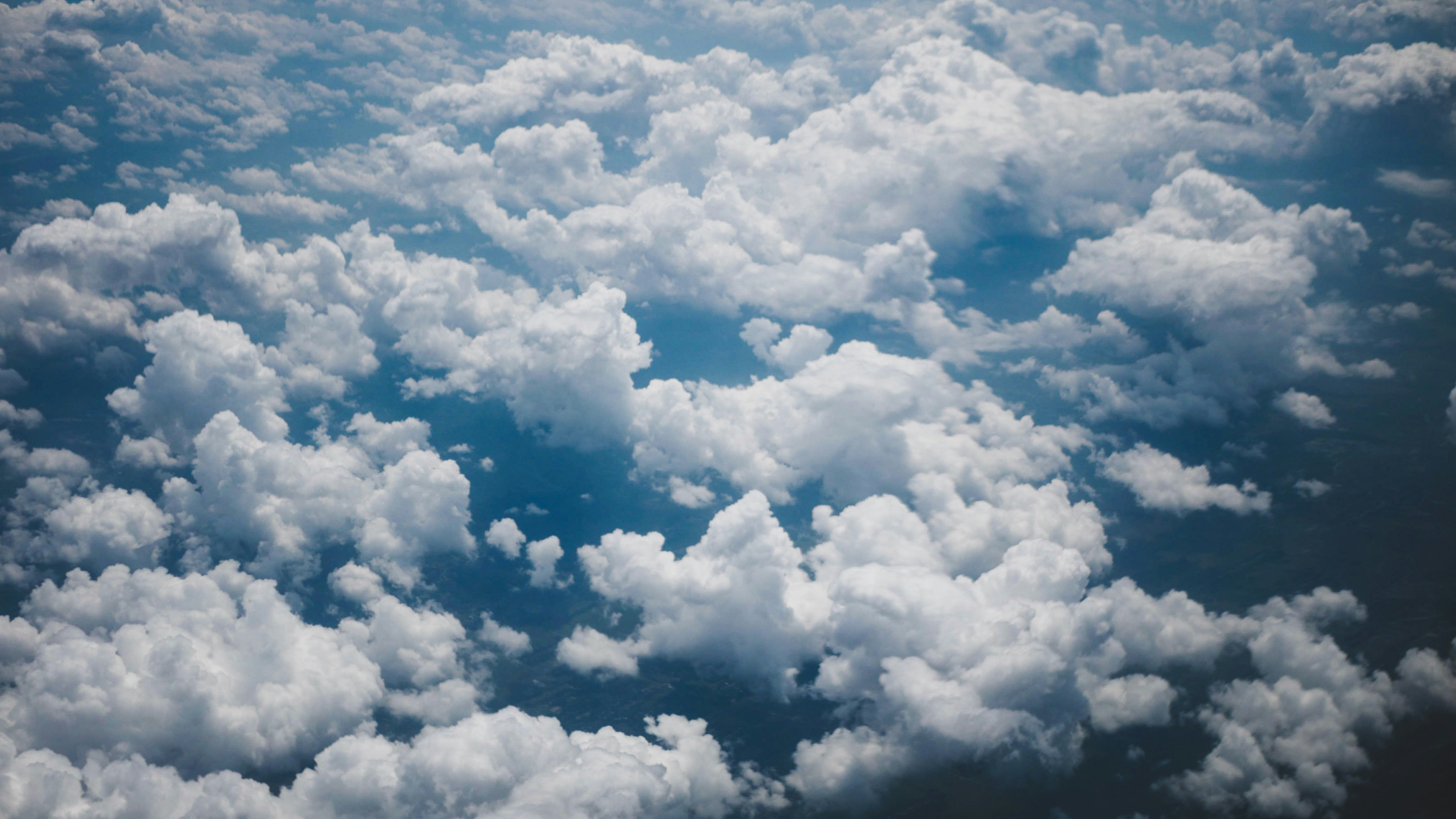 Fluffy white clouds against a blue sky