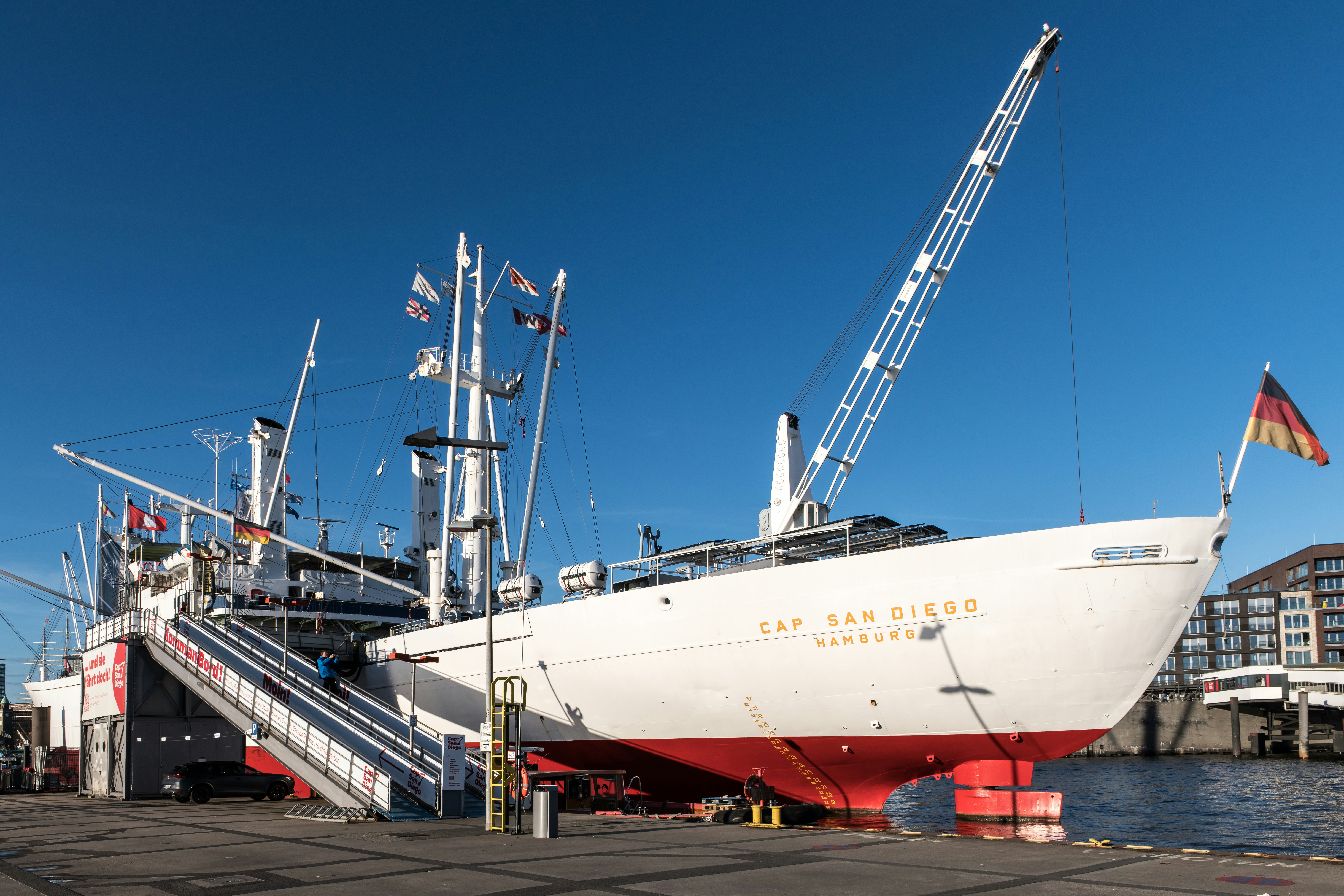 Large white ship docked with german flag