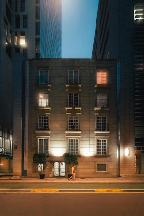 Modern building facade with illuminated windows at dusk