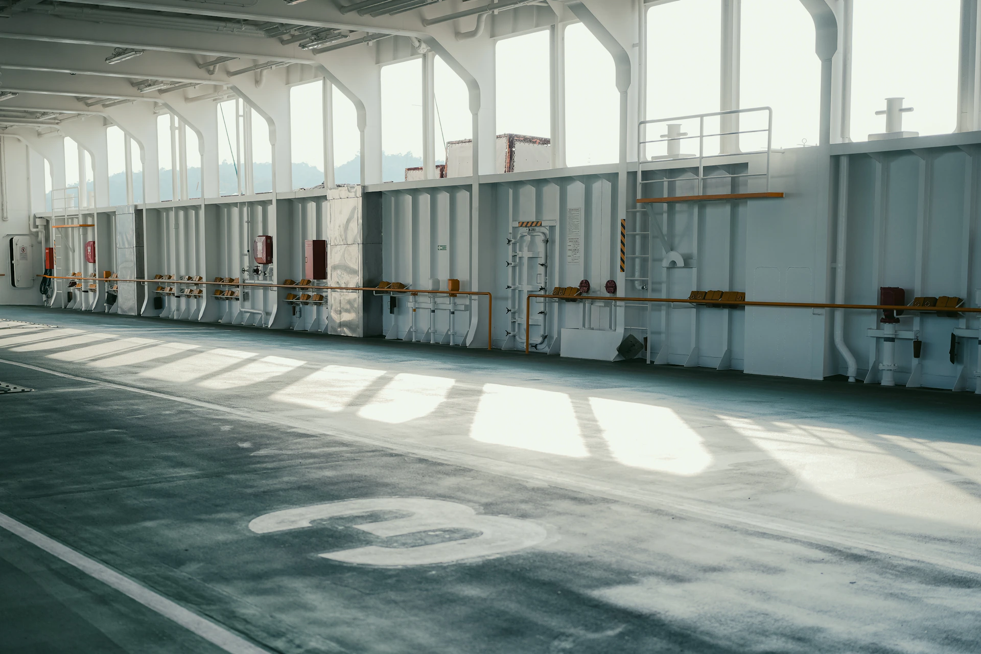 Sunlight streams into a large empty industrial space